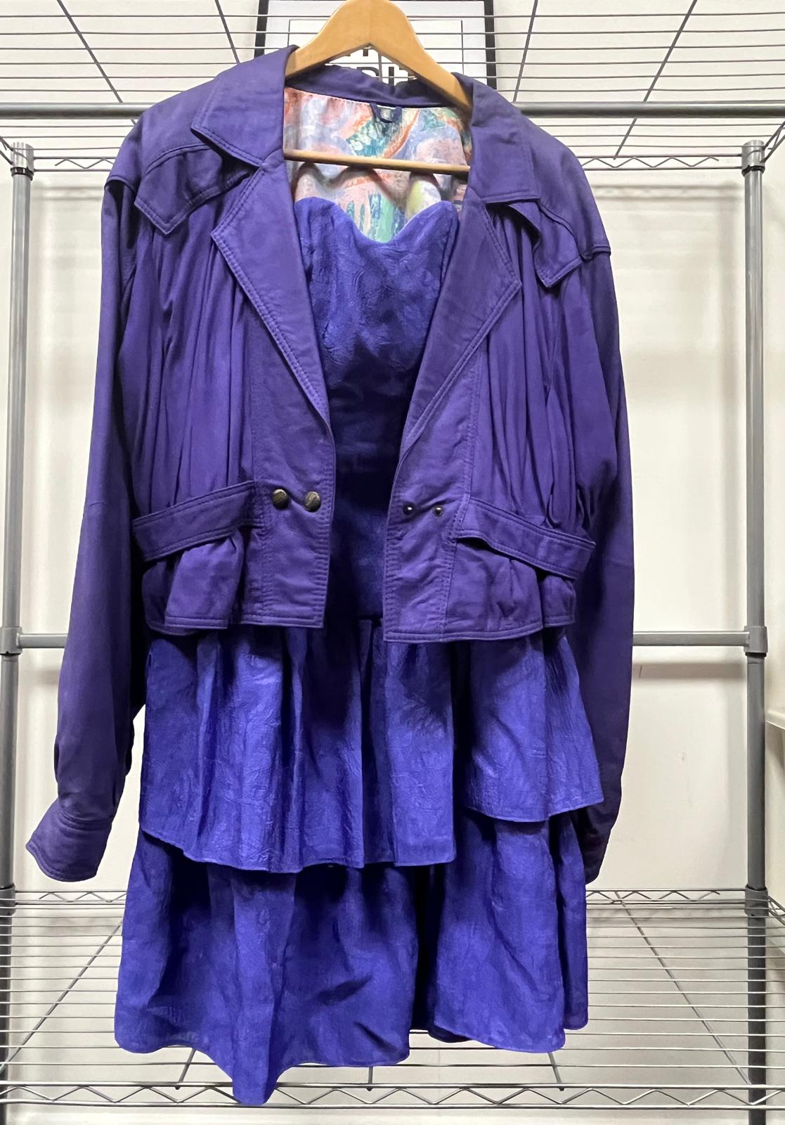 Vibrant purple dress and matching jacket on hanger
