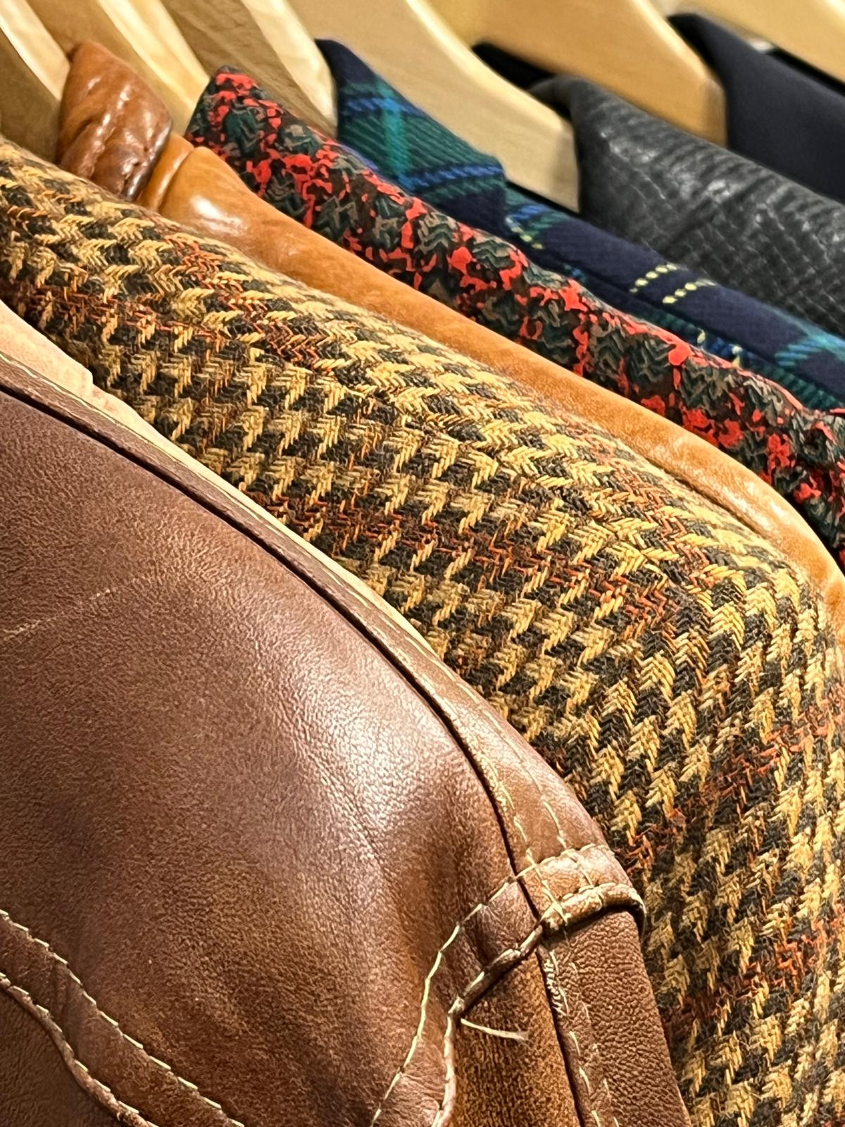 Checked and plain jackets on hangers