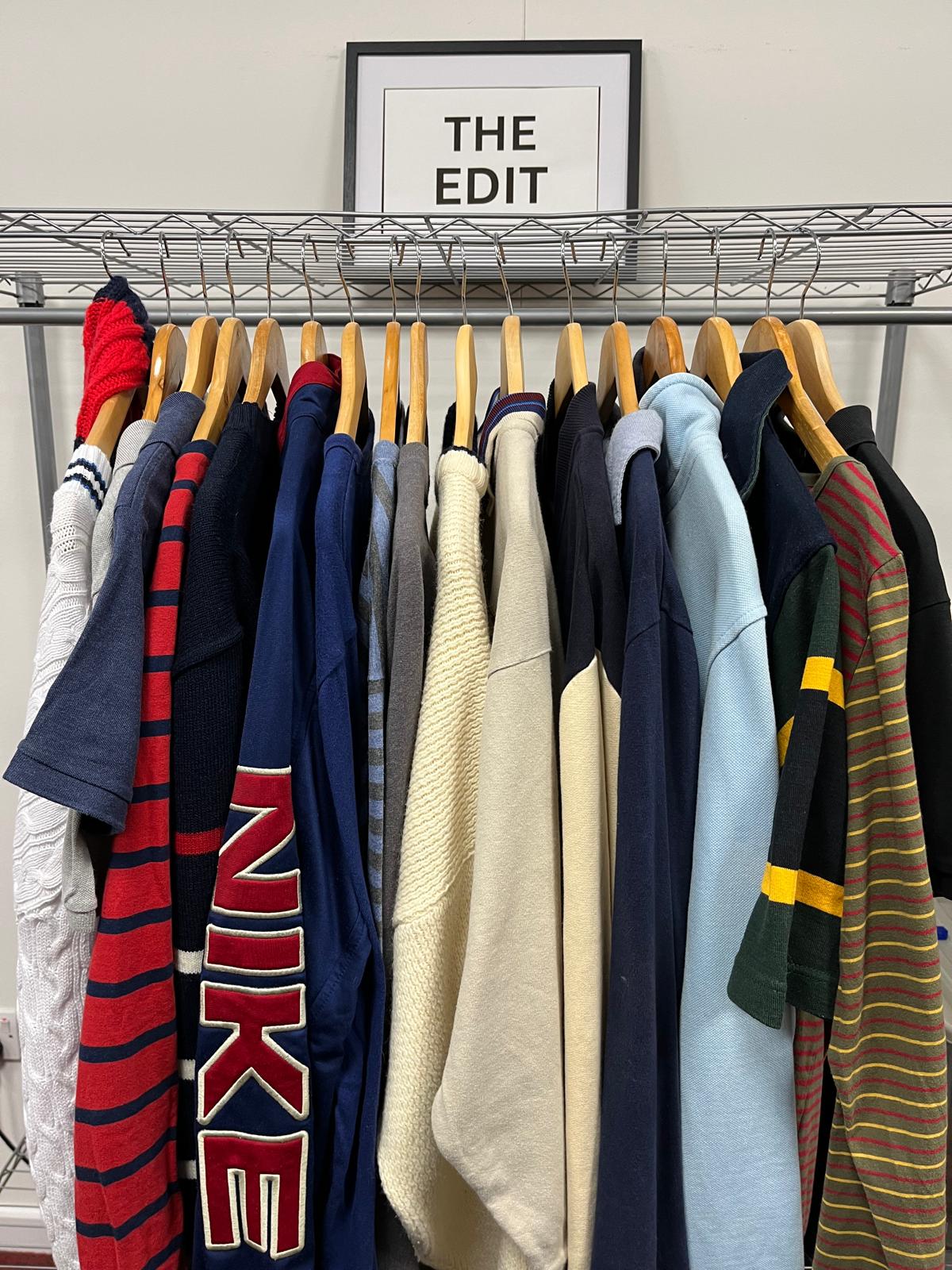 Polo shirts and sweaters on hangers