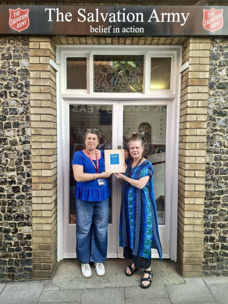 From left, Jemma Banks wearing blue t-shirt and jeans while Maria Zacharias, the shop manager stands next to her. Both hold David Hockney book