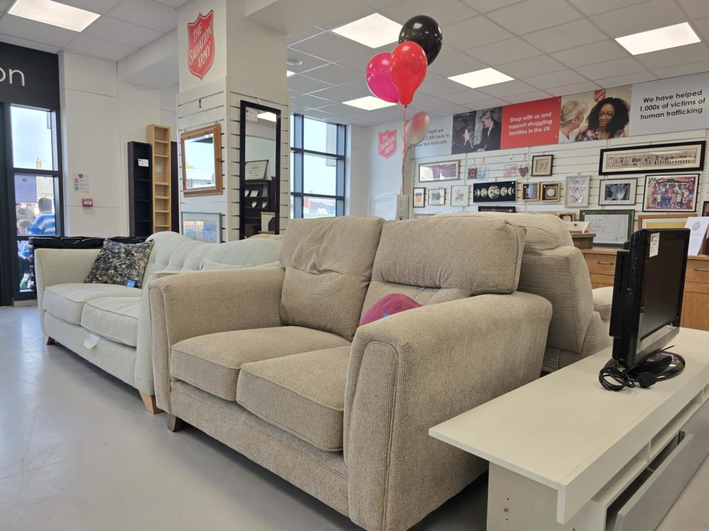 Picture of light grey sofa on the shop floor inside Salvation Army donation centre in Taunton